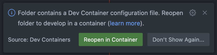 A notification from a Visual Studio Code indicates that the folder contains a Dev Container configuration file. The message suggests reopening the folder to develop in a container and provides a link to learn more. There are two buttons: "Reopen in Container" in green and "Don't Show Again..." in gray. The source of the notification is the "Dev Containers" extension.